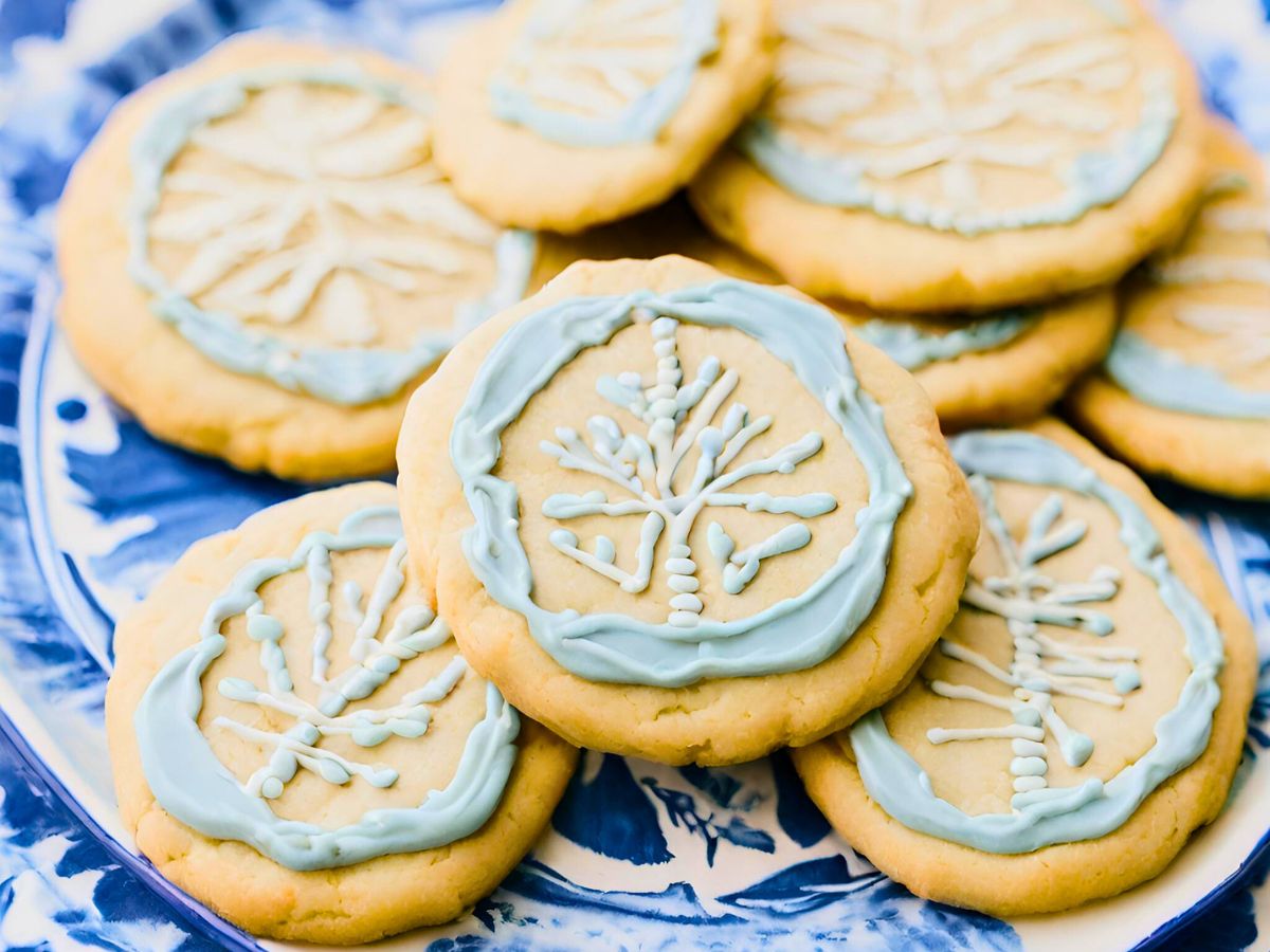 einkorn sugar cookies decorated with blue and white frosting on a blue and white plate 
